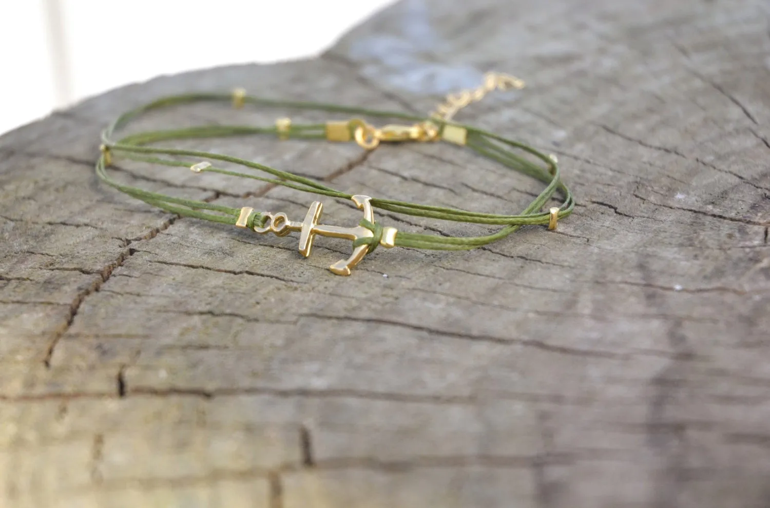 Handmade green dainty anklet with a gold anchor charm and gold beads